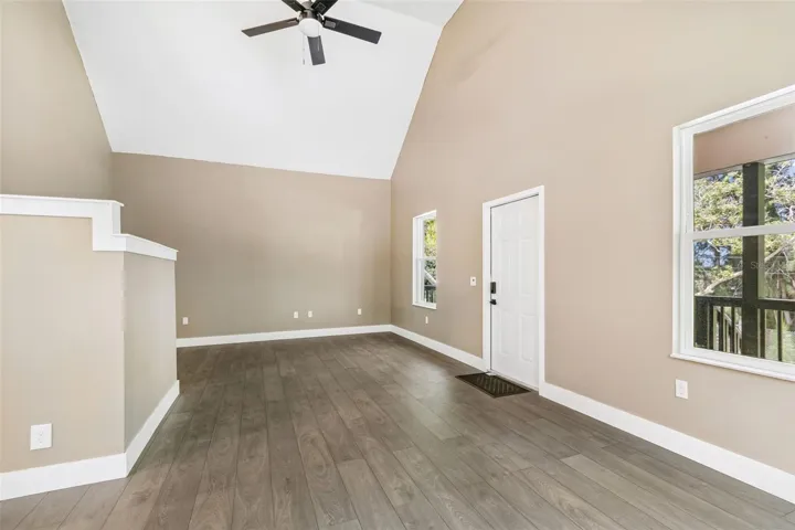 View of the front door from the inside &amp; living room