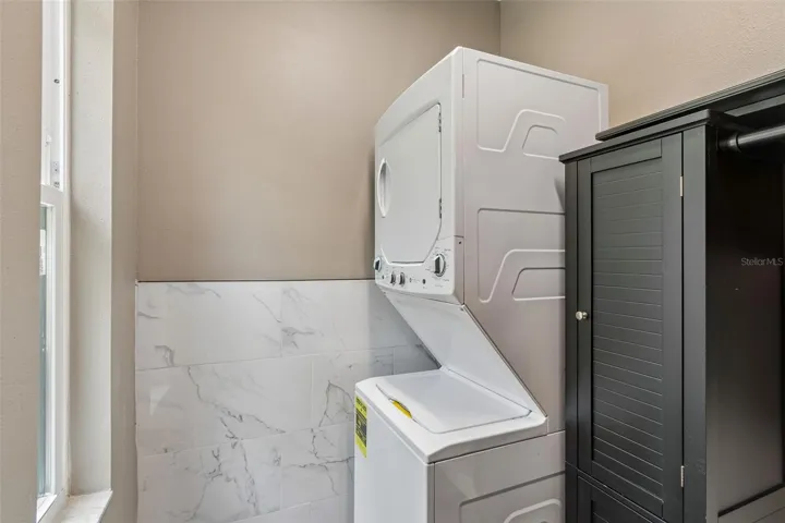 Stackable washer &amp; dryer located next to the kitchen
