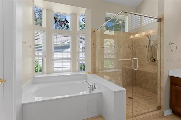 Updated glass shower enclosure in Primary Bathroom