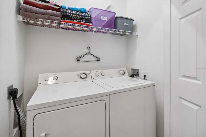 Laundry closet with new washer and dryer.