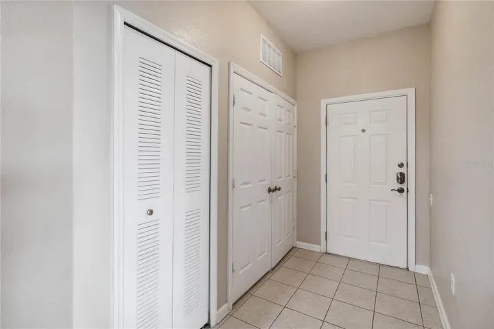 Entrance hallway showing laundry closet on the left.