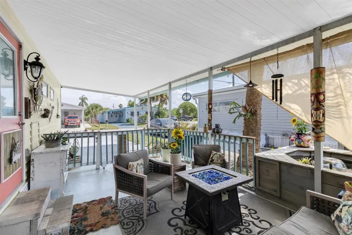 Seating area in the breezeway with gas fire pit.