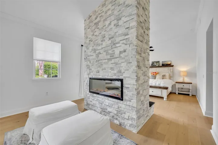Double sided fireplace in First Floor Primary Bedroom