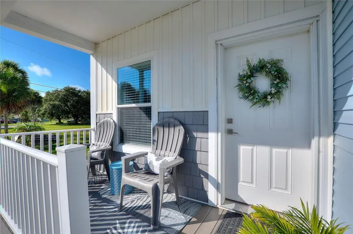 Relax, unwind and enjoy Florida lifestyle on the covered front patio