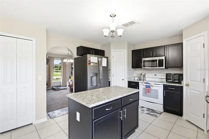 Upgraded kitchen: Granite counters, custom handles and cabinet inserts, duel pantries, upgraded appliances and lighting
