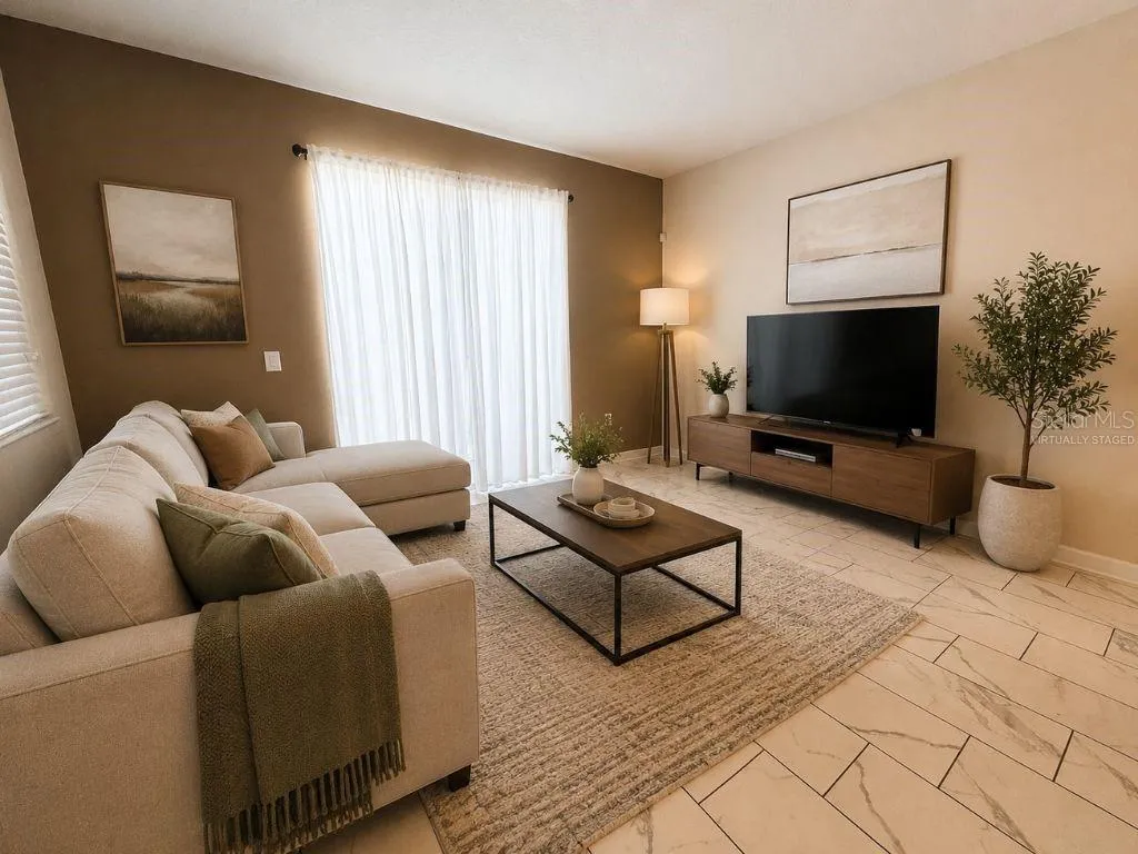 Virtually staged living room highlighting a bright, inviting space with comfortable seating, neutral finishes, and a relaxed vacation-home feel.