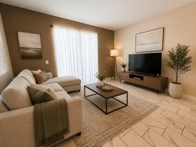 Virtually staged living room highlighting a bright, inviting space with comfortable seating, neutral finishes, and a relaxed vacation-home feel.