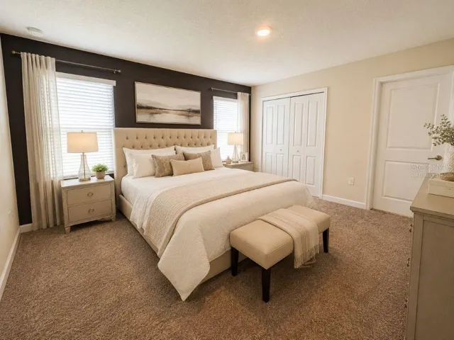 Virtually staged primary bedroom highlighting a spacious, comfortable retreat with neutral finishes, soft natural light, and a relaxing resort-style feel.