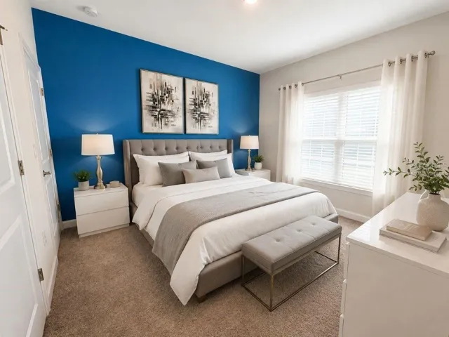 Virtually staged downstairs bedroom highlighting a bright, comfortable layout with modern neutral decor and a bold accent wall.