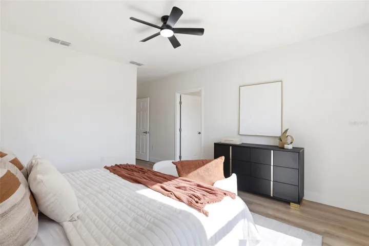 Primary suite shown staged to highlight the room size, layout, and furniture placement.
