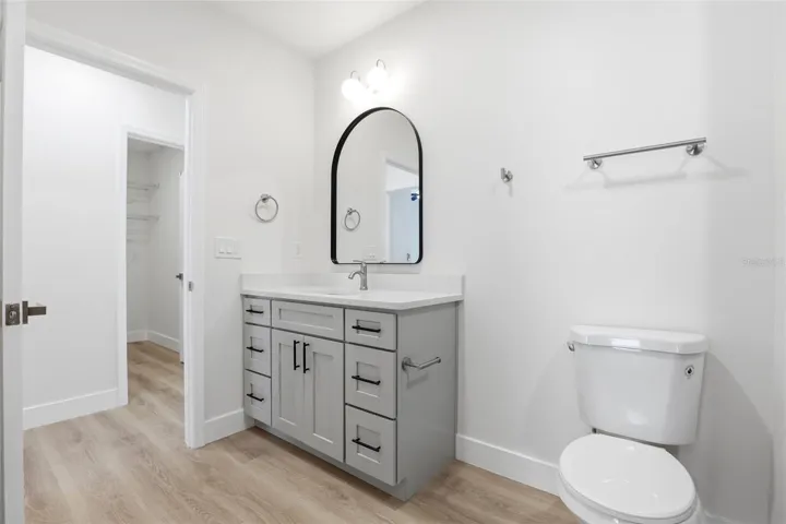 Full guest bathroom with attractive vanity, modern mirror, and clean neutral finishes.
