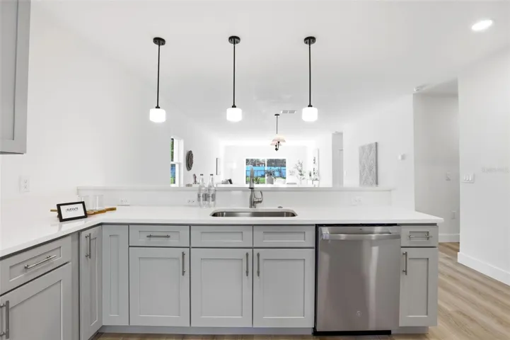 Granite island kitchen with stainless steel appliances and a fresh, modern Leesburg home design.