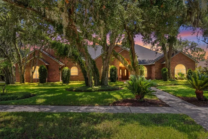 As evening settles in, the home's warm glow hints at the elegance, comfort, and memorable moments waiting within.