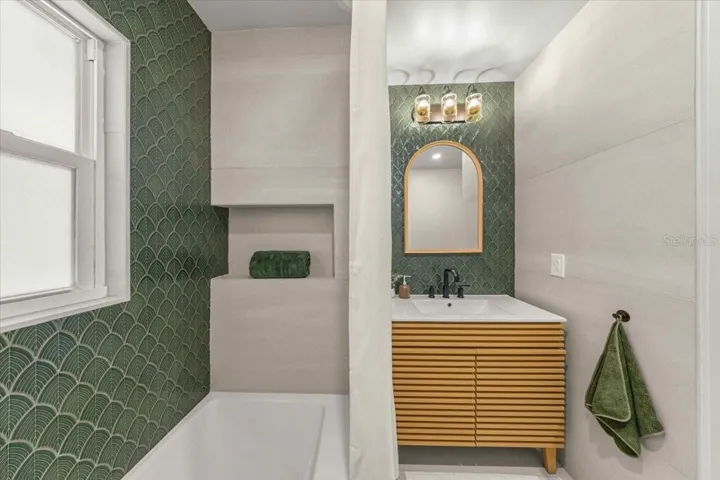 Tiled tub/shower combo, new vanity and tiled backsplash
