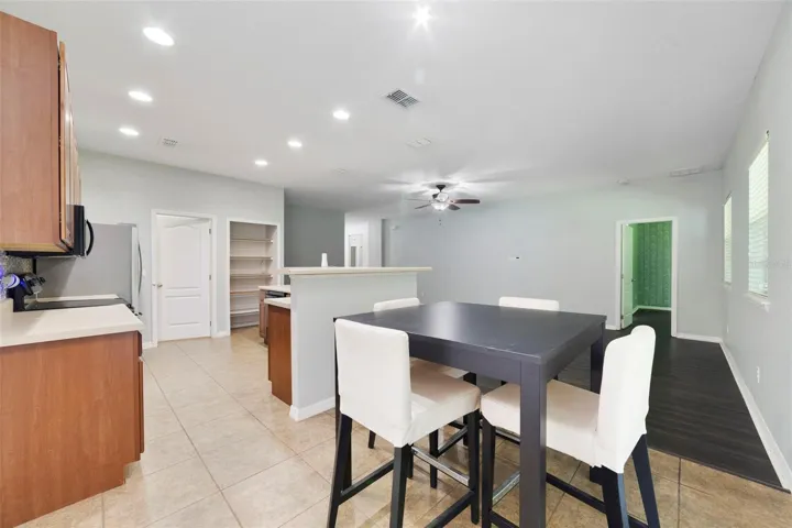 An adjoining EAT-IN DINING AREA provides the perfect spot for casual meals while overlooking the backyard.