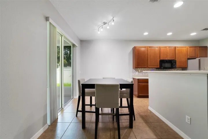An adjoining EAT-IN DINING AREA provides the perfect spot for casual meals while overlooking the backyard.