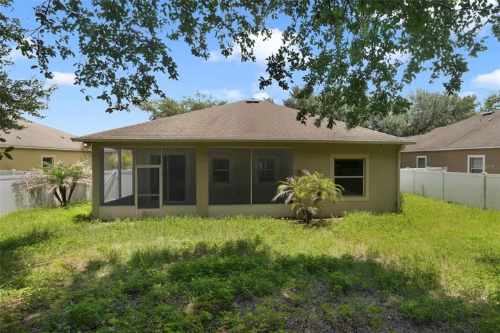 The large fenced backyard boasts plenty of room for pets, play, gardening, or future outdoor enhancements.