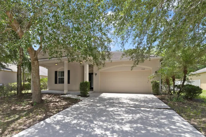 Framed by MATURE SHADE TREES that enhance its curb appeal, this inviting single-story home offers comfortable living, a functional floor plan, and a spacious backyard perfect for enjoying the Florida lifestyle. Welcome Home!
