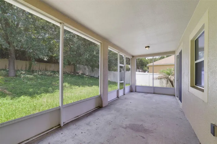 Sliding glass doors from the dining space lead to an ENCLOSED, SCREENED REAR PORCH.