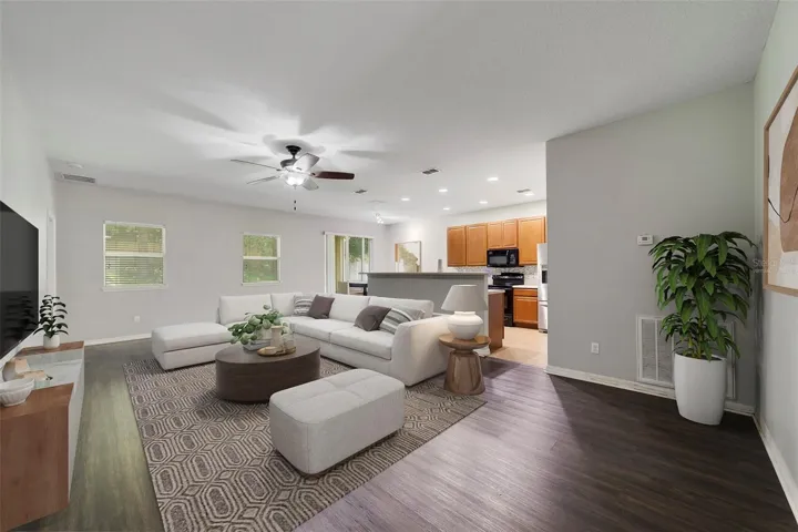 The welcoming Living Room boasts LUXURY VINYL PLANK FLOORING and abundant natural light create a warm, inviting atmosphere. Virtually Staged