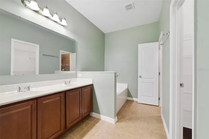 The Primary EN SUITE BATH is complete with dual sinks, a GARDEN TUB, and a separate step-in shower.