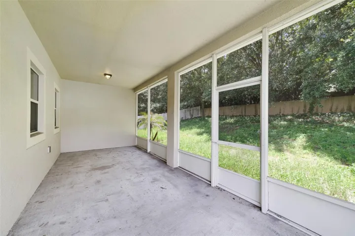 Sliding glass doors from the dining space lead to an ENCLOSED, SCREENED REAR PORCH.