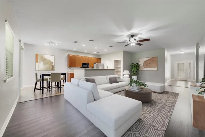 Step through the ELEGANT ETCHED GLASS FRONT DOOR into a bright and welcoming Living Room, where LUXURY VINYL PLANK FLOORING and abundant natural light create a warm, inviting atmosphere. Virtually Staged