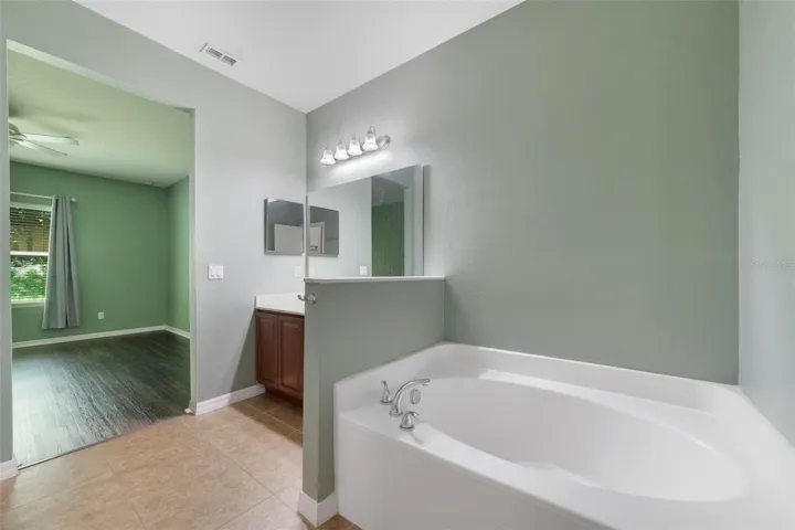 The Primary EN SUITE BATH is complete with dual sinks, a GARDEN TUB, and a separate step-in shower.