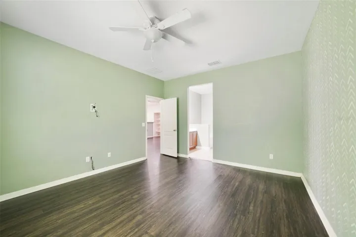 The spacious Primary Suite serves as a relaxing retreat with a walk-in closet and a private EN SUITE BATH.