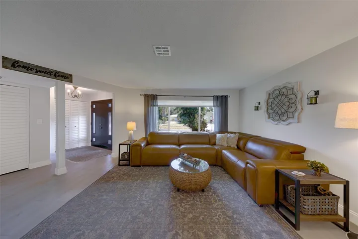 Living room with view of front door and more closet space