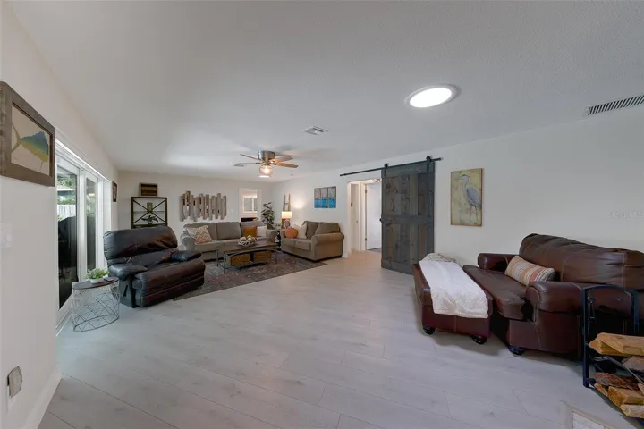 Family room with 3 door sliders opening up to the pool