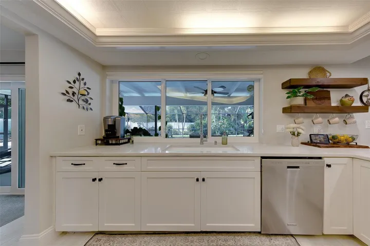 Bright and beautiful kitchen with windows that open up to the pool