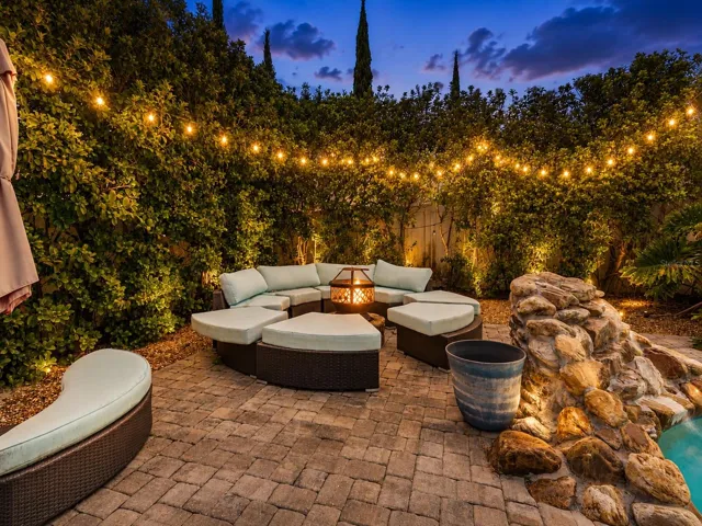 The home SHOW STOPPER-swimming pool with rock water fall, brick paver decking, private cabana, shrubs for privacy, and more.