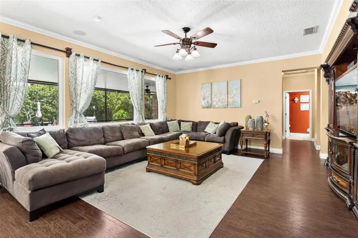 Family Room features laminate wood flooring, windows replaced in 2017, and overlooks Kitchen.