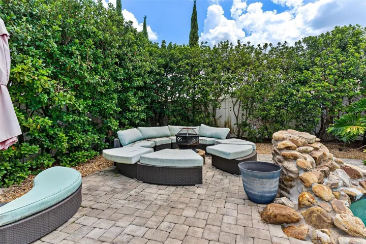 The home SHOW STOPPER-swimming pool with rock water fall, brick paver decking, private cabana, shrubs for privacy, and more.