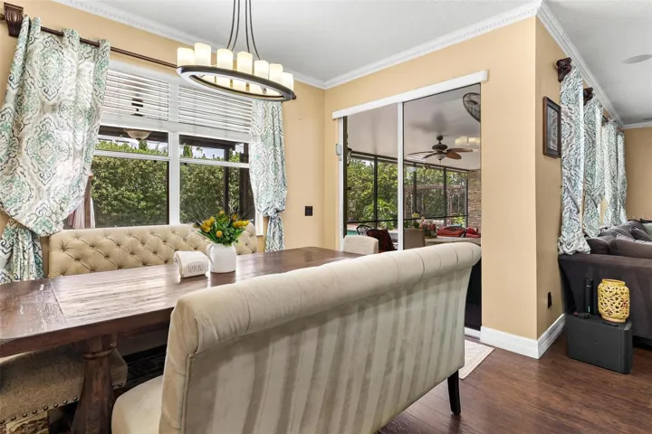 Dinette overlooks kitchen and sliders leading to screened enclosed lanani.