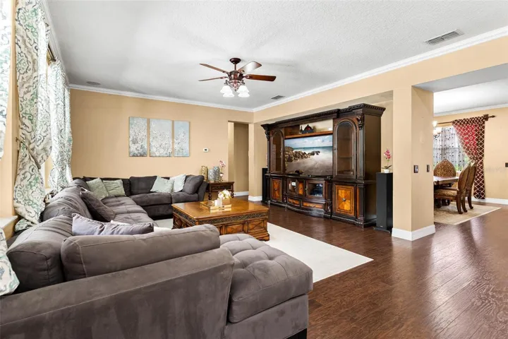 Family Room features laminate wood flooring, windows replaced in 2017, and overlooks Kitchen.