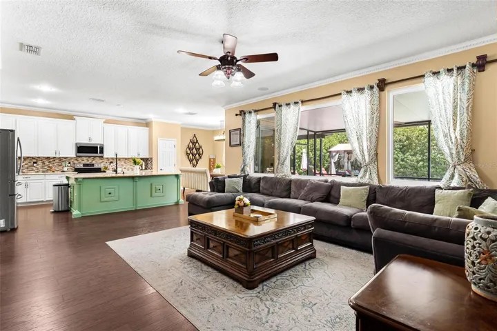 Family Room features laminate wood flooring, windows replaced in 2017, and overlooks Kitchen.