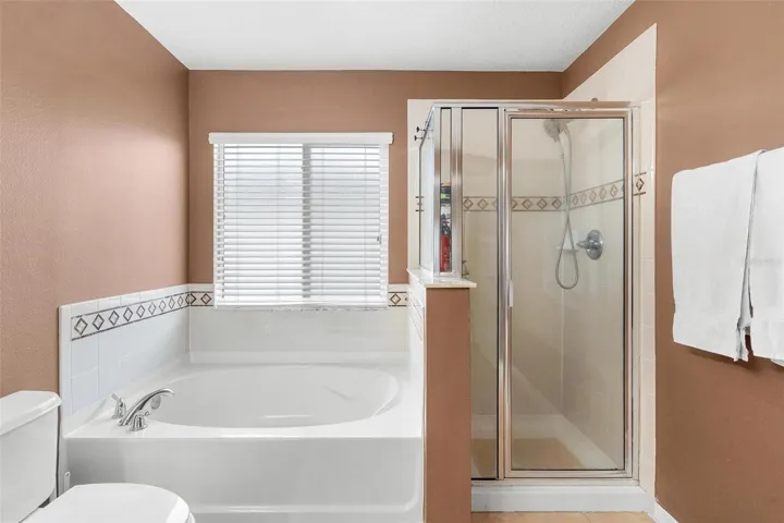 Primary Bathroom features dual vanity sinks, garden tub, and walk in shower.