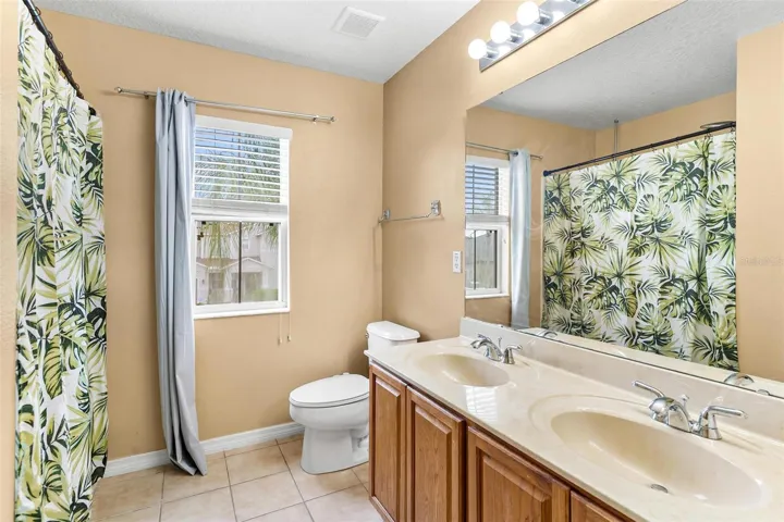 Guest Bathroom features dual vanity sinks and shower/tub combo