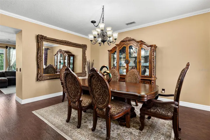 Formal Dining Area features laminate wood flooring overlooking formal living area.