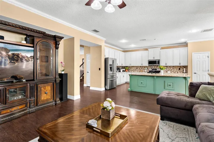 Family Room features laminate wood flooring, windows replaced in 2017, and overlooks Kitchen.