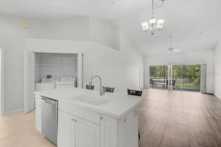 Kitchen island, showing indoor laundry and great room