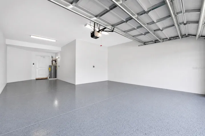 Photo Staged/Edited to Remove Items from Garage  - 2 Car Garage with Additional Space for Golf Cart.