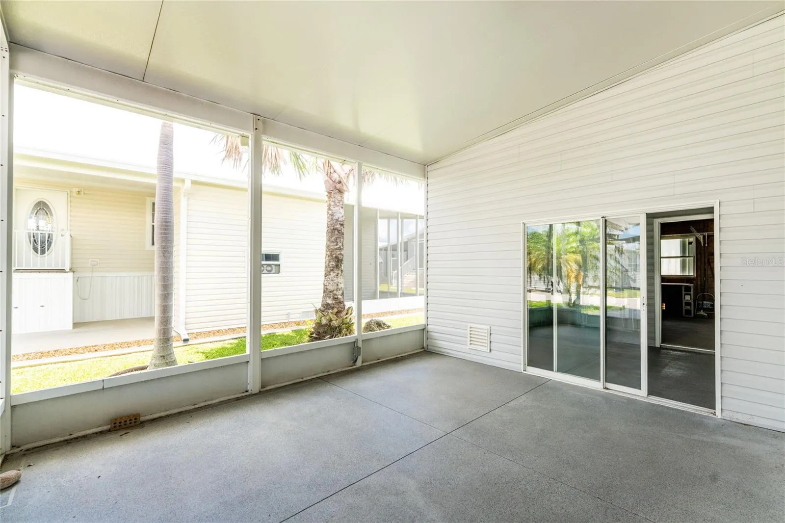 Screened porch which leads you to storage and wood working room