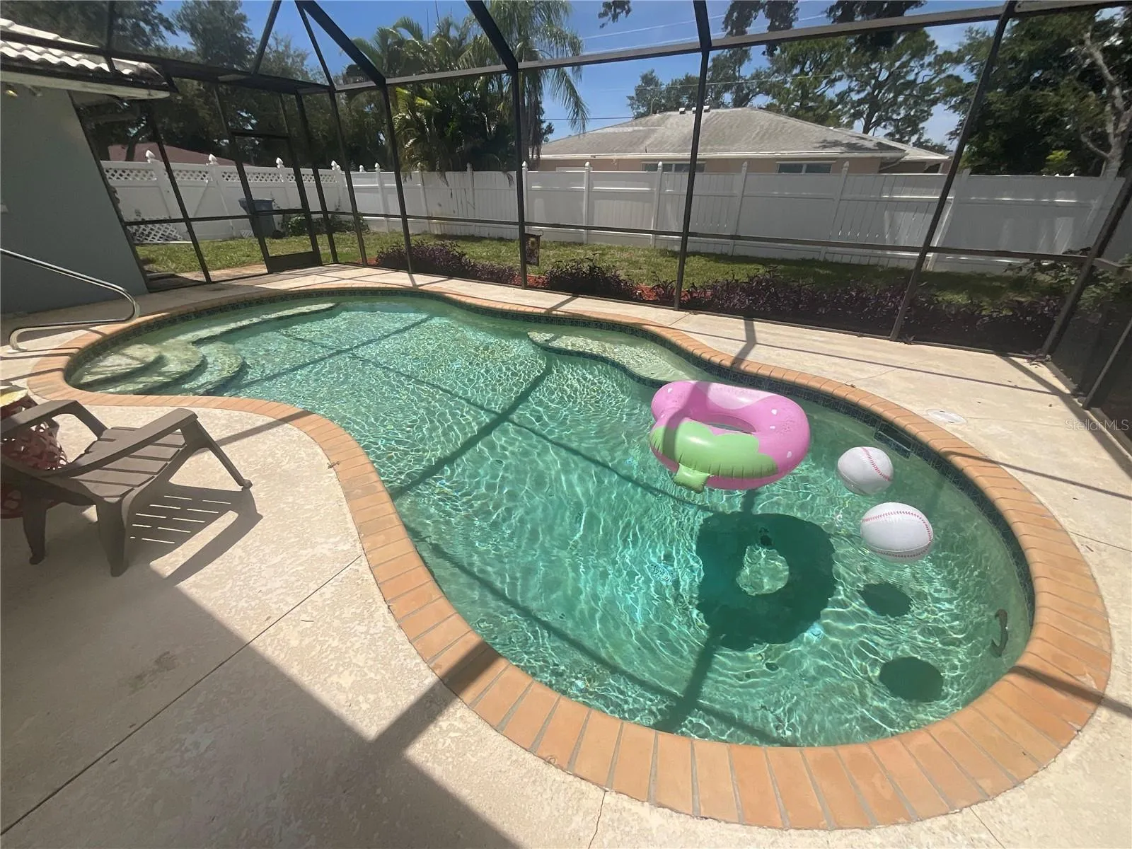 Relax pool side, nice bench area to side across from steps