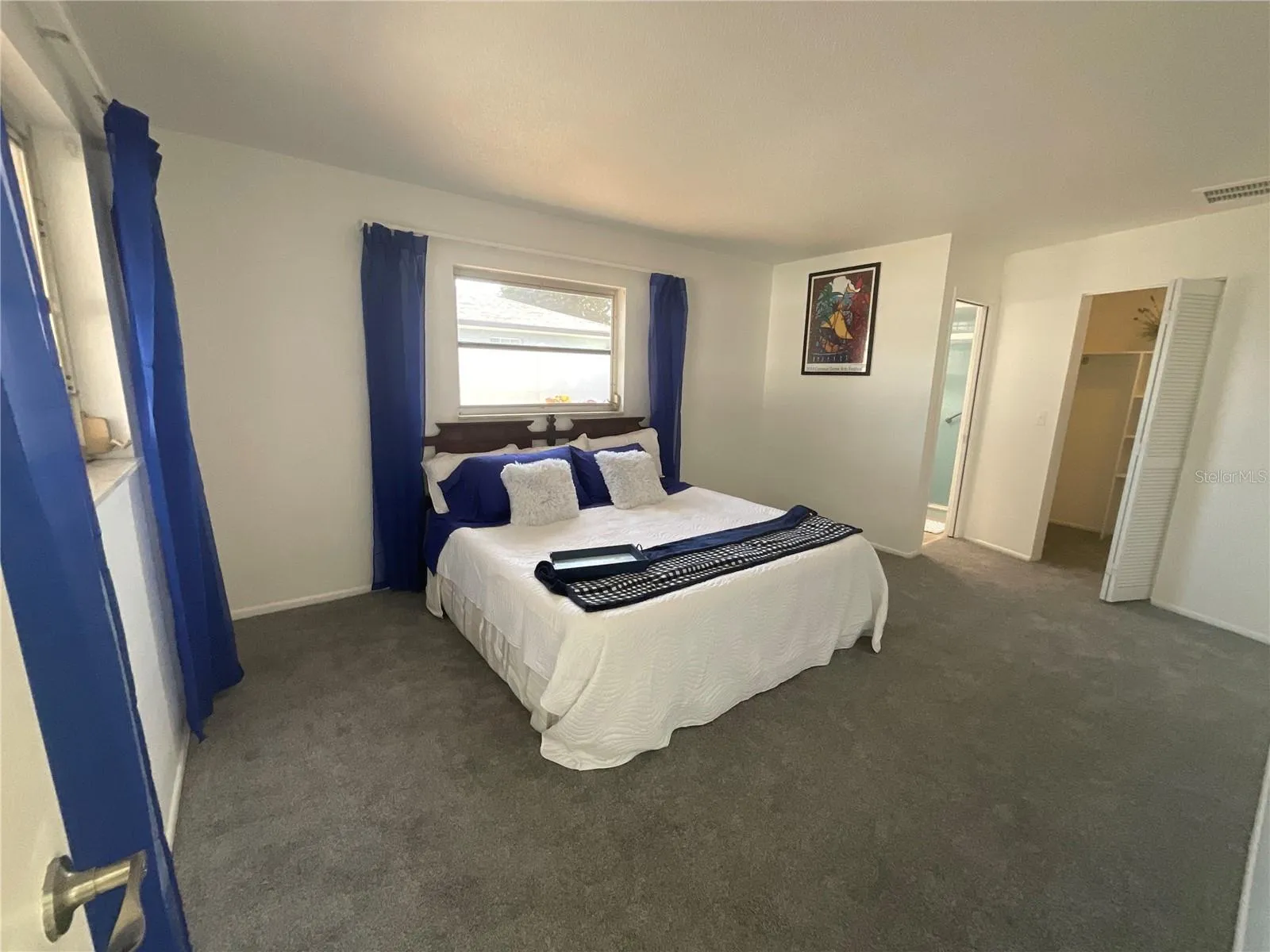 View of en-suite bathroom in the primary suite, notice the king size bed!