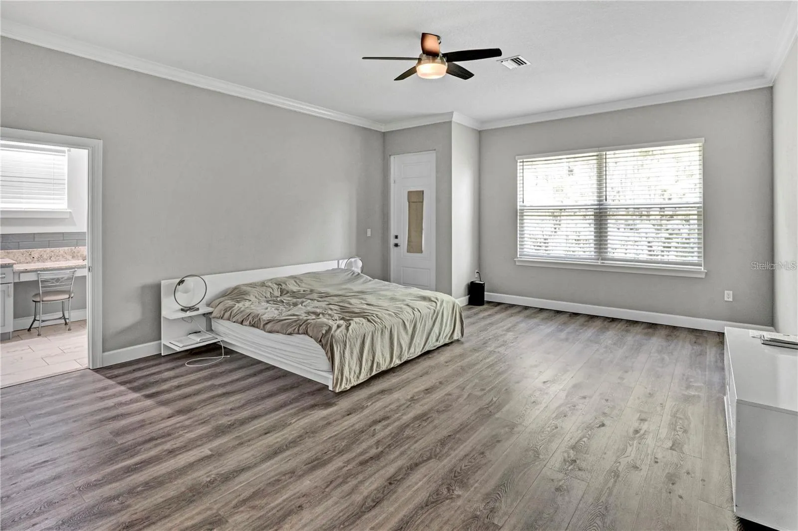 The oversized primary suite offers a serene retreat with ample space for a king-sized bed, featuring a private entrance and direct access to the en-suite bath
