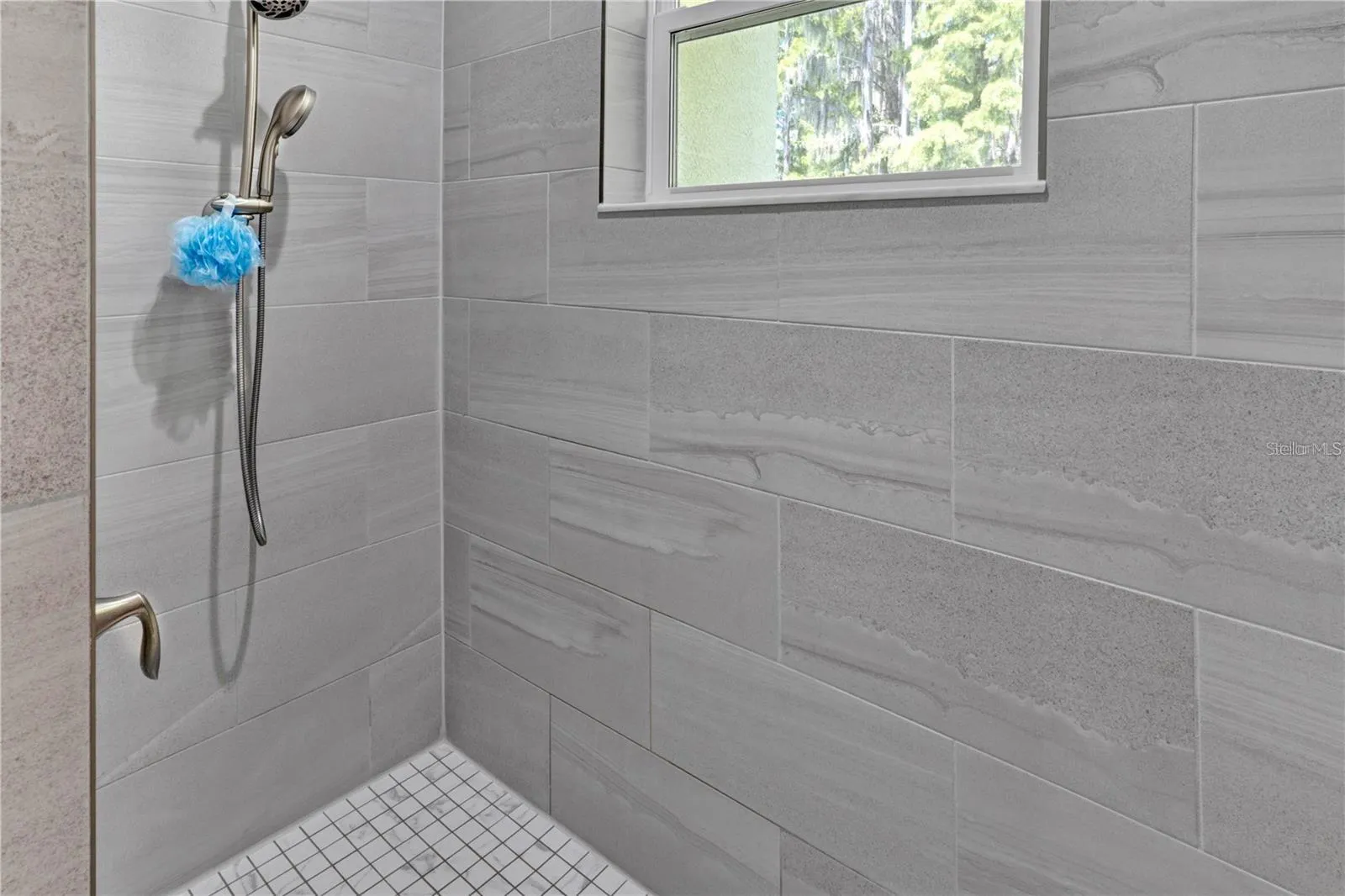 Large spacious shower in the primary bathroom.