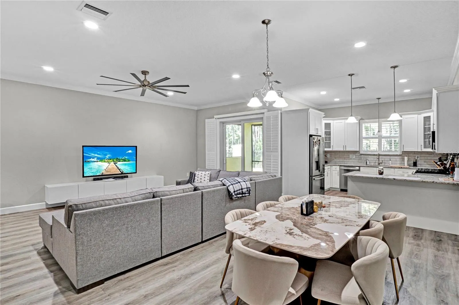 Perfect for entertaining, the seamless transition between the dining room, living area, and kitchen creates a bright, airy, and connected atmosphere.
